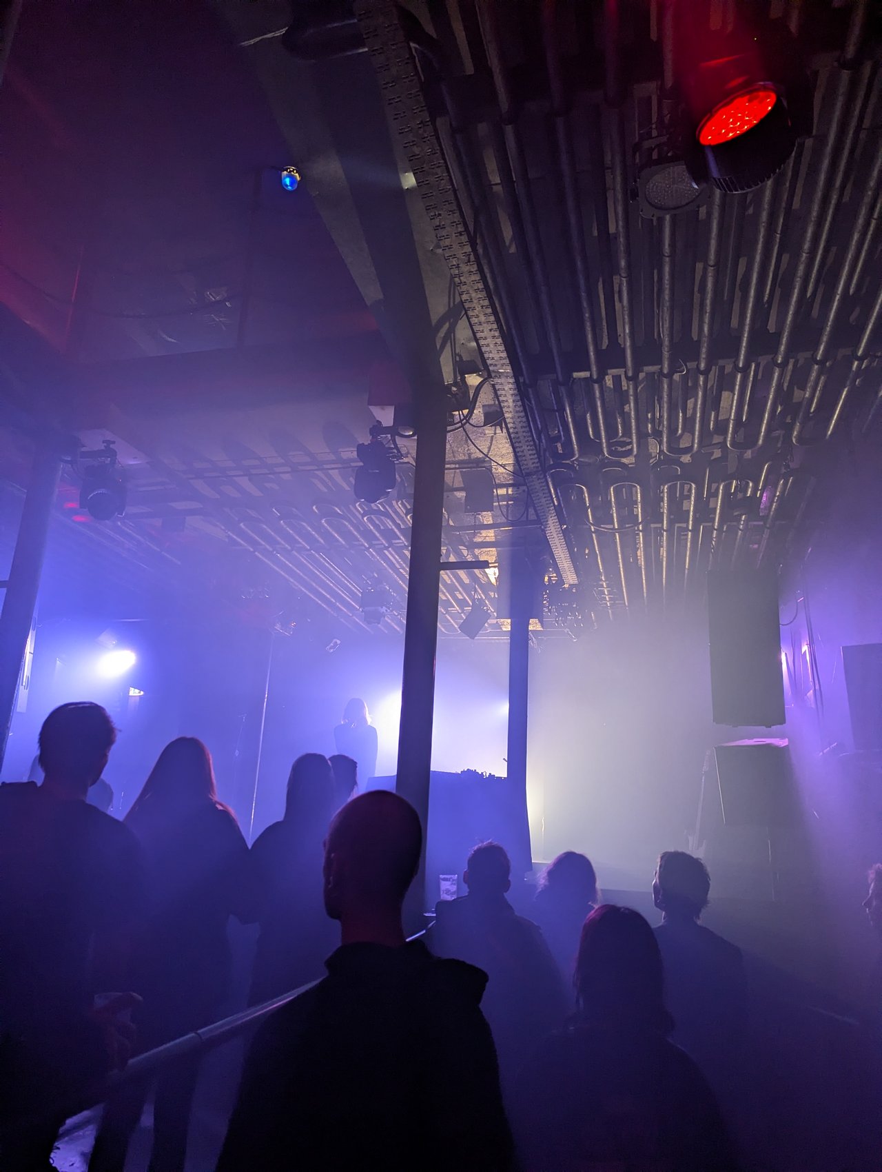 View of the stage from the main space. Woman singing.